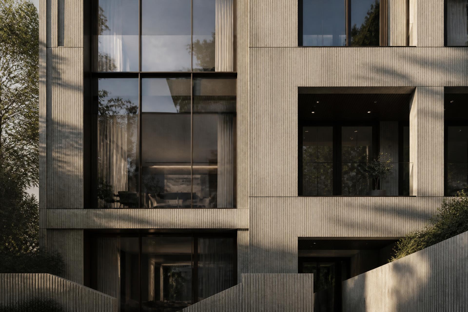 Contemporary residential architecture with fluted stone facade in late afternoon light