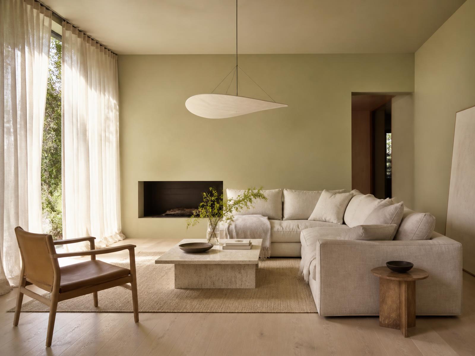Minimal living space with pale oak floors, plaster walls and linen seating